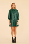 Model is wearing the Dolce Cabo Soft Vegan Leather Dress in Forest Green. A mini shift silhouette with soft faux leather, 3/4 puff sleeves, and front button detailing