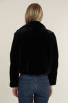 Back view of model in black fur coat