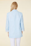 Back view of model in a light blue linen blazer. Stripped lining that shows when cuffed