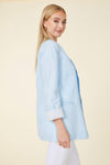 Model in a light blue linen blazer. Stripped lining that shows when cuffed