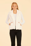 Smiling model in the Dolce Cabo Faux Fur Vest - White, a white faux fur vest with a fold over collar and pockets 