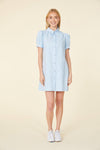 Full body view of short light blue dress, with buttons up the front, and puff sleeves