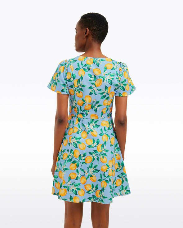 Back view of model in the Draper James Mae Love Circle Dress - Lemon Blossom