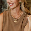 Model in the Susan Shaw Gold Cross Front Toggle Necklace