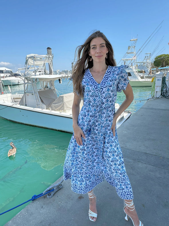 Model in the Islapayal Amalfi Maxi Dress - Hellenic Blue standing in front of a boat