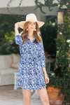 Model outside in a woven hat wearing the  Duffield Lane Camila Dress in Navy Blossoms
