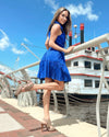 Outdoor side view of the Duffield Lane x Lucky Knot Exclusive Ann Dress - Bright Blue Metallic