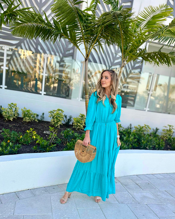 Model outside wearing Teal Maxi Dress with Tiered skirt and 3/4 Sleeves