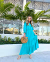 Front View of Model Outside Wearing Teal Maxi Dress with Tiered skirt and 3/4 Sleeves