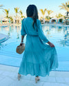 Back View of Model by Pool Wearing Teal Maxi Dress with Tiered skirt and 3/4 Sleeves