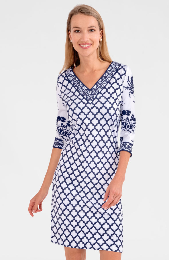 Blonde woman wearing navy and white geometric print 3/4 sleeve v-neck dress with contrast crab print on sleeves 