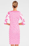 Blonde woman facing away wearing pink and white geometric print 3/4 sleeve dress with contrast crab print on sleeves 