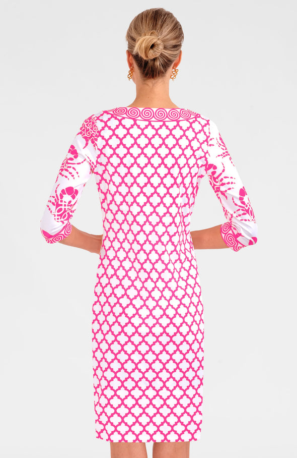 Blonde woman facing away wearing pink and white geometric print 3/4 sleeve dress with contrast crab print on sleeves 