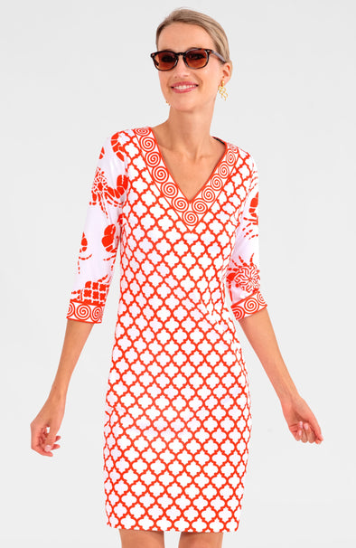 Blonde woman in sunglasses wearing orange and white geometric print 3/4 sleeve v-neck dress with contrast crab print on sleeves 