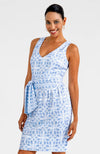 Smiling model in the Gretchen Scott Jersey Date Night Dress - Ring Toss - Periwinkle. A sleeveless dress with a v-neck and a belted waist