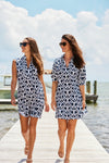Two models near the water, the left model wearing Jude Connally Kristen Dress in JC Ikat Navy