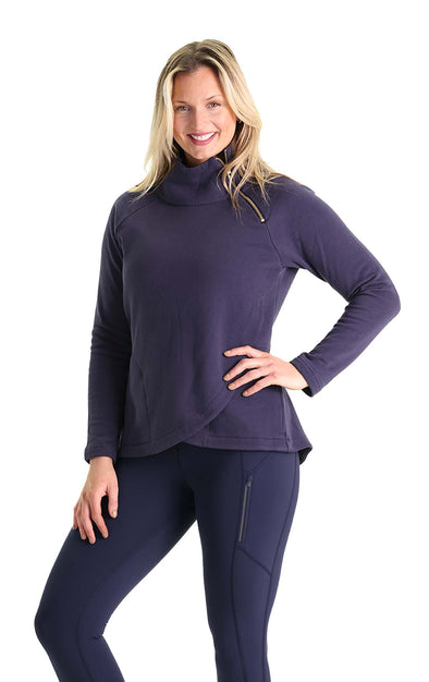 Smiling model in the Duffield Lane Lexington Sweatshirt in navy. A mock neck sweatshirt with a gold zipper detail