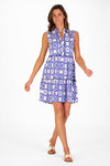 Model in a sleeveless blue tile patterned mini length dress