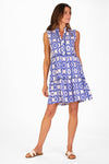 Model in a sleeveless blue tile patterned mini length dress 