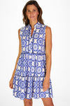 Model in a sleeveless blue tile patterned mini length dress 