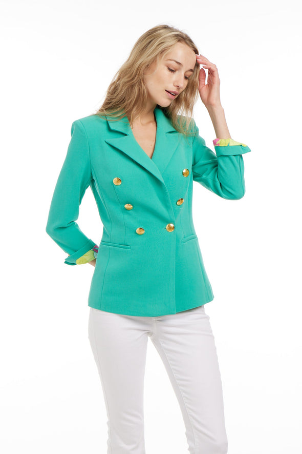 Model wearing Patty Kim Bermuda Jacket in Spring Green with Gold Buttons and Tropical Print Inside Fabric