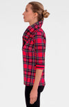 Woman wearing a red and black plaid shirt on a white background