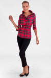 Woman wearing a red and black plaid shirt with black pants on a white background