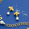Flat view of the Susan Shaw Handcast Bee + Pearl Drop Earrings