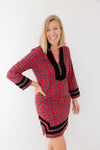 Playful model in Sail to Sable Tunic Dress in Red Plaid