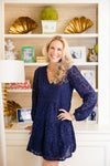 Cropped view of the model in the Sail to Sable Navy Floral Eyelet Long Sleeve V-Neck Dress 