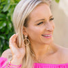Model in the Jenny Bamboo Drop Hoop Earrings - Worn Gold