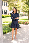 Model outside in Jude Connally Henley Dress in Denim Navy