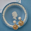 Flat view of the Queen Elizabeth Coin Pearl Drop Earrings - Worn Gold
