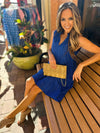 Model sitting in Duffield Lane x Lucky Knot Exclusive Annika Dress- Bright Blue Metallic Stripe