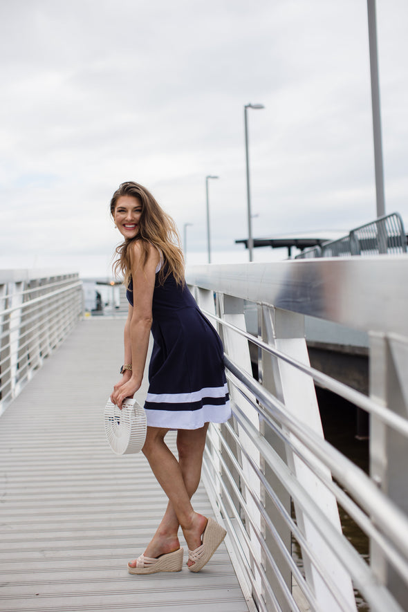 Side view of outdoor model in Duffield Lane Carroll Dress - Navy/White