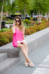 Model in sunglasses wearing Jude Connally Bailey Dress in Spring Pink