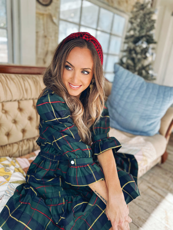 Seated model in Gretchen Scott Teardrop Dress in Plaidly Cooper in Green Plaid