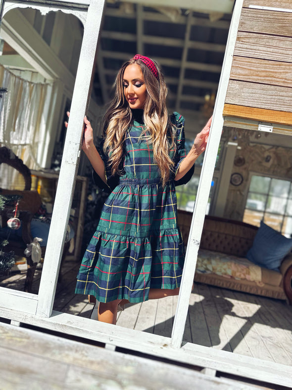 Model in a doorway in Gretchen Scott Teardrop Dress Plaidly Cooper Green Plaid