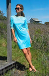 Model outside wearing Gretchen Scott Rocket Girl Dress in Turquoise/Gold