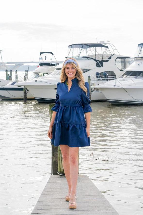 Outdoor model on a dock in the Gretchen Scott Teardrop Dress 