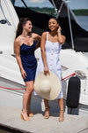 Two models on a dock, left model wearing Jude Connally Bailey Dress in Navy