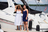 Two models on pier, right wearing Jude Connally Bailey Dress in Navy