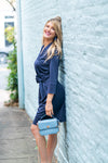 Model against wall wearing Gretchen Scott Dapper Dress in Solid Navy