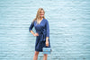 Model outdoors wearing Gretchen Scott Dapper Dress in Solid Navy