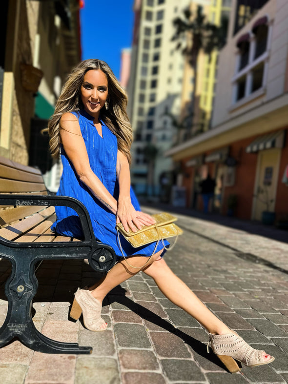 Model sitting in Duffield Lane x Lucky Knot Exclusive Annika Dress- Bright Blue Metallic Stripe