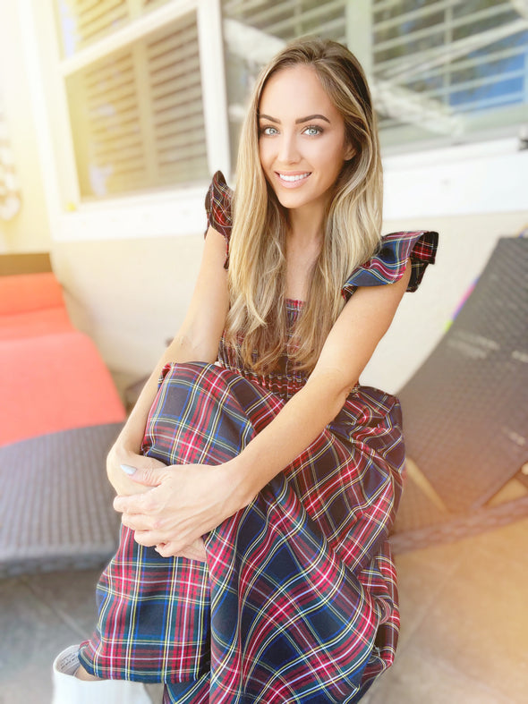 Model seated in The Holly Dress