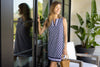 Model outside wearing Jude Connally Carissa Dress in Daylily Woodblock Navy