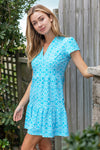 Model outside wearing Jude Connally Ginger Dress in Diamond Ikat Santorini Blue