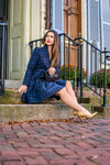 Sitting view of Sail to Sable Highlands Dress - Blackwatch Plaid