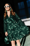 Out of focus shot of the Sail To Sable Charlotte Sequin Dress - Emerald